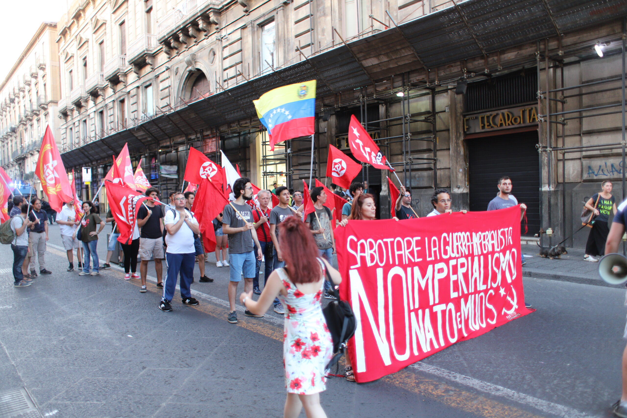 This is a small street demonstration on a wide Italian street