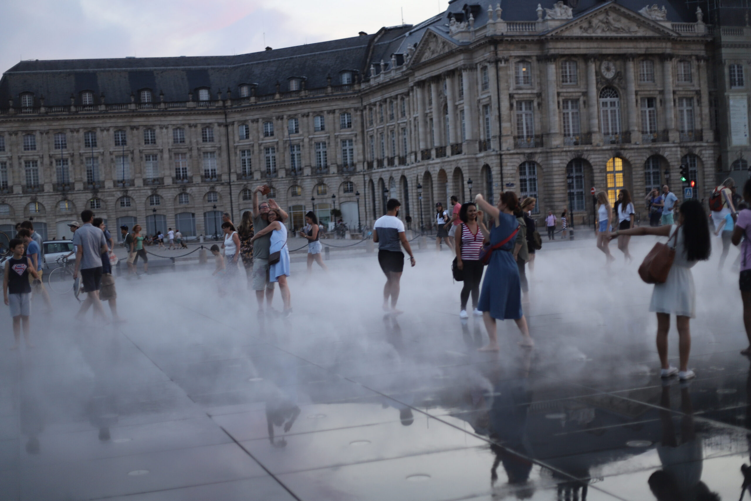 The Miroir d'eau in front of the Place de la Bourse in Bordeaux, caught as daylight fades into early blue hour