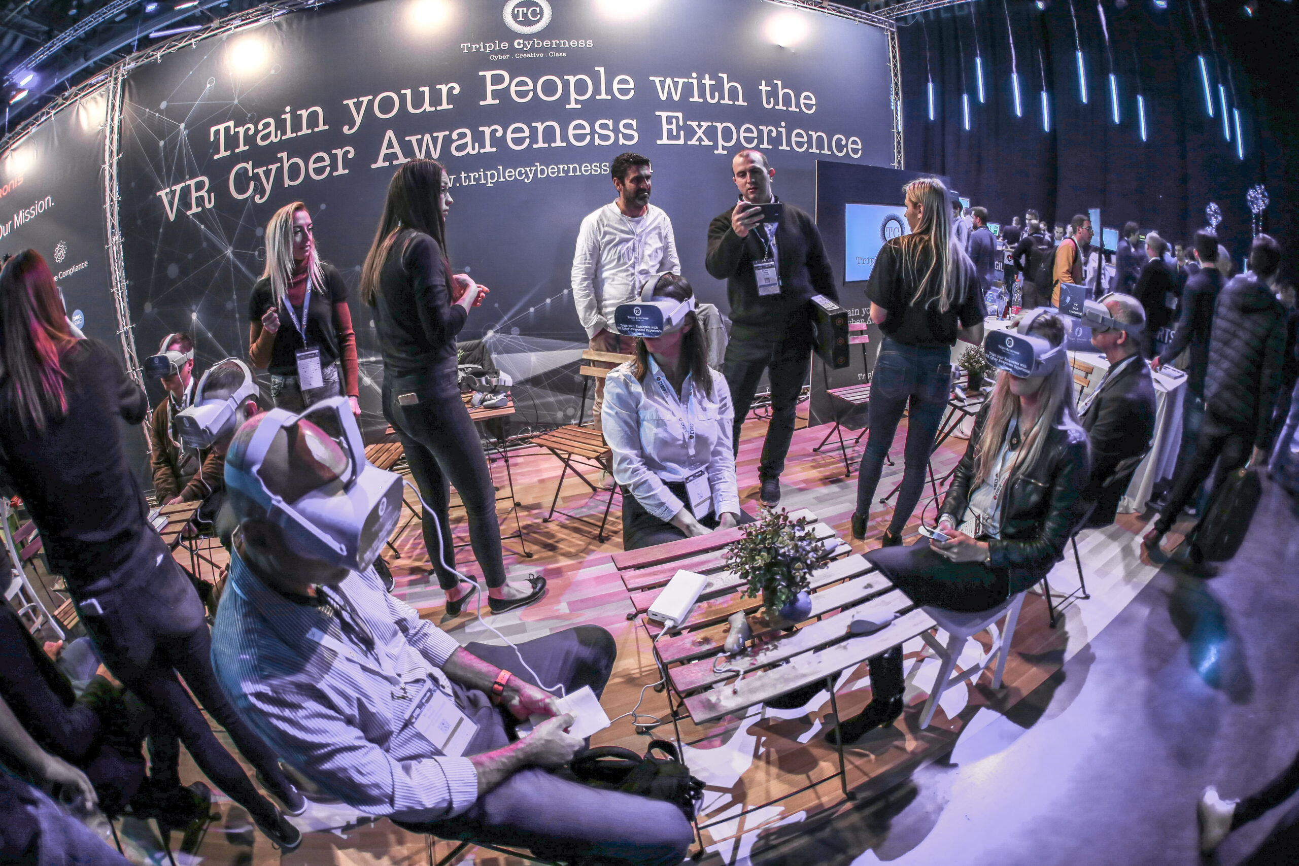 Conference visitors wearing VR headsets at a cyber awareness training booth